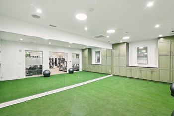 A gym with green flooring and white walls.
